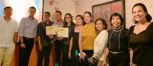 Photo of M Lhuiller recognized as the most compliant agent by Western Union after annual compliance review